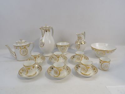 a white and gold tea set on a white table