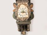 une horloge accrochée au mur, entourée d'une chaîne