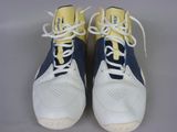 pair of white and blue sneakers with yellow laces on them