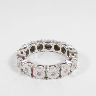 an image of a diamond and white gold ring on a white surface