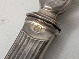 a silver spoon with a handle on a table