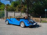 a blue car that is parked in a parking lot
