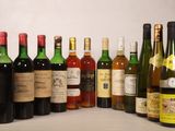 many bottles of wine that are lined up on a shelf