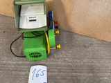 a computer on the ground next to a piece of paper