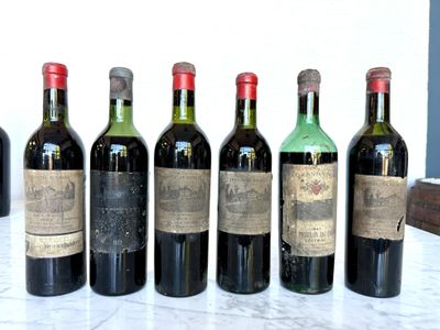 six bottles of wine are lined up in a row on a table