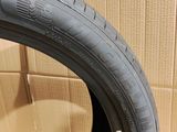 tire on the floor of a room with a cardboard box in the background