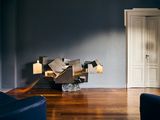 an image of a living room with dark blue walls and wood floors