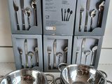 three sets of silverware are sitting on a counter in front of a box