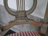 a wooden chair with a striped seat and back
