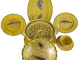a lot of yellow dishes and bowls with fish on them