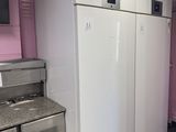 an image of a kitchen with a refrigerator, stove, and dishwasher