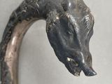 a close up of a metal handle with a horse head on it