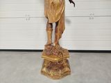 a statue of a man holding a bird in his hand