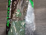 a plastic bag with a pair of green gloves in it