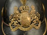 a helmet that has a coat of arms and a crown on it