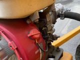 a close up of a small engine on the back of a motorcycle