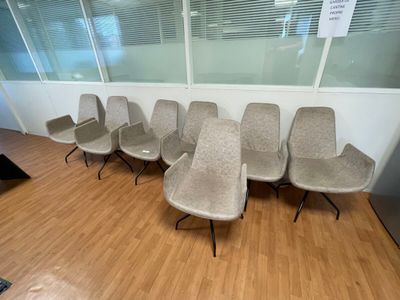 a row of chairs in a waiting room with a sign on the wall