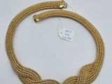 un collier plaqué or composé de trois anneaux et d'un fermoir