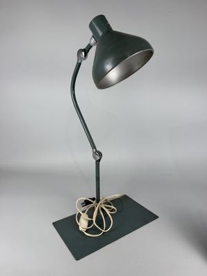 an image of a green desk lamp on a black base