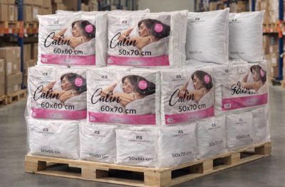several rolls of toilet paper stacked on a pallet in a warehouse