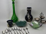 a lot of silver spoons and silverware on the table