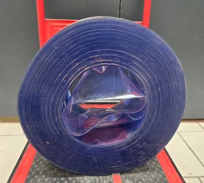 a roll of blue tape sitting on top of a red cart