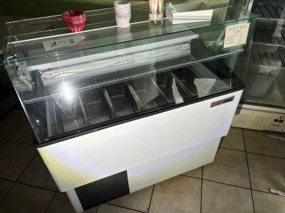 an ice cream shop with a glass display case