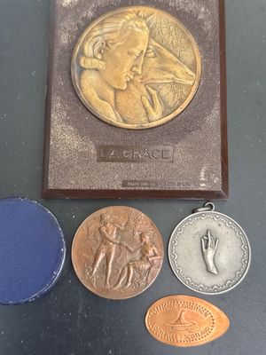 three medals and a book on a table