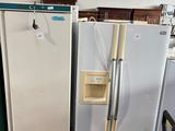 several refrigerators and freezers in a warehouse with chairs and tables