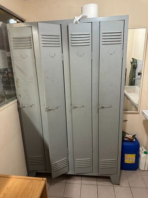 two lockers in a bathroom with a toilet and a sink