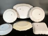 five plates and two bowls sitting on a black table