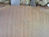 a close up of a vase with two heads on it