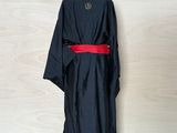 an image of a black robe with a red belt on a mannequin