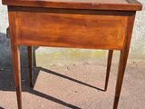 a small wooden table with a drawer on top of it
