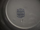 a white plate with a blue and white design on it