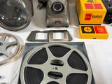 a camera, a film reel, and other items laid out on a table