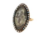 un gros plan d'une bague sur laquelle figure le portrait d'une femme