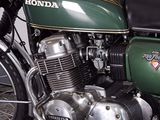 a green motorcycle that is parked in a garage