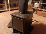 a small stove sitting on the floor in a room