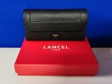 a close up of a red box with a black purse on top of it