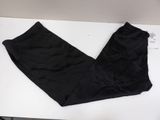 black pants sitting on a white table with a tag on it