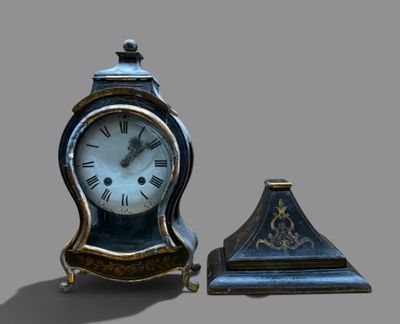 a small clock sitting next to a smaller clock on a table