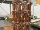 a large stack of sticks sitting on a table in a warehouse