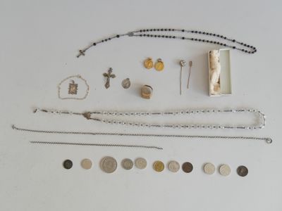 an image of a collection of silver and gold jewelry on a white surface