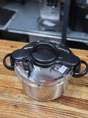 a pot with a lid on a wooden table