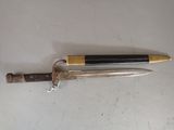 a knife that is laying on a table next to a knife