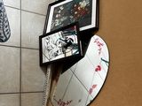 a picture of a bathroom with a mirror and pictures on the wall