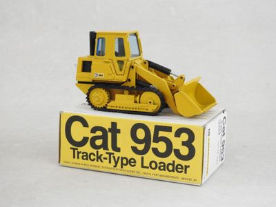 a yellow cat 953 track type loader sitting on a box
