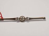 an image of a silver and gold tie bar with a red string