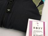 a black shirt with a camouflage print on it and a tag on it